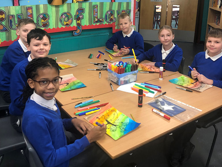 A group of children doing artwork
