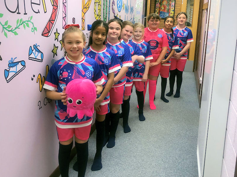 Our girls wearing their new football kit